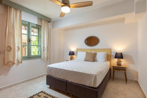 a bedroom with a bed and a window at Cumbalıca Beach Hotel in Cesme