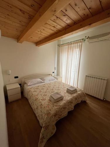 a bedroom with a bed with two boxes on it at Casa “il riposo del pescatore” in Porto San Giorgio
