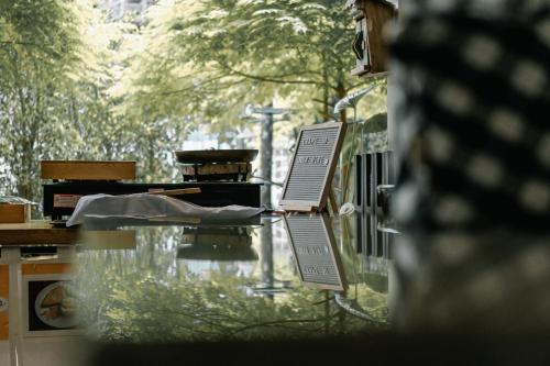 a glass table with a sign on top of it at Qoo Hotel in Buriram