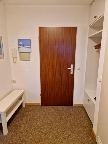 a door in a room with a bench and a table at Panorama Apart Bad Säckingen in Bad Säckingen