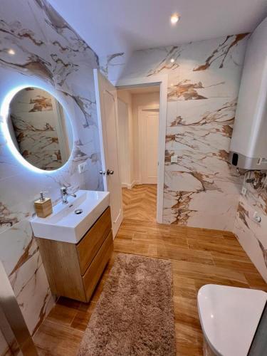 a bathroom with a sink and a mirror at MIA HOME MARBELLA in Marbella