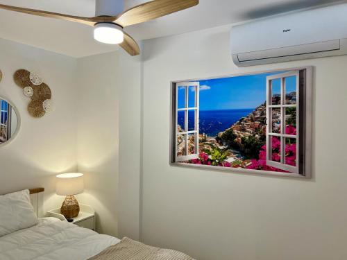 a bedroom with a bed and a window with a view at MIA HOME MARBELLA in Marbella