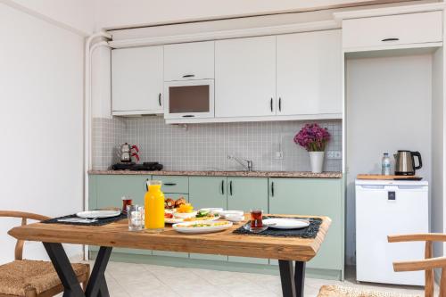 a kitchen with a table with food on it at Cumbalıca Beach Hotel in Cesme