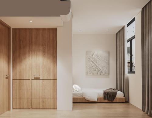a bedroom with a bed and a wooden door at Alma House in Singapore