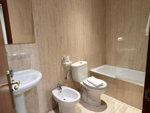 a bathroom with a toilet and a sink at Hotel Sancho in Hospitalet de l'Infant