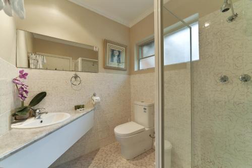 y baño con aseo, lavabo y ducha. en The Waterfront Wynyard en Wynyard