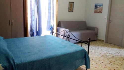 - un salon avec un lit et un canapé dans l'établissement Casa Vacanza Trappeto Palermo 2, à Trappeto