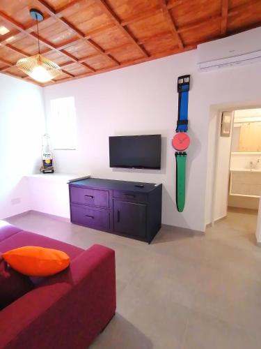 a living room with a couch and a flat screen tv at Casa del Cigno in Monterotondo