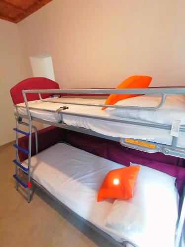 a room with three bunk beds in a room at Casa del Cigno in Monterotondo