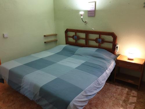 a bedroom with a blue bed with two night stands at Apartamento Vistasol Ins in Torremolinos