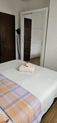 a bedroom with a bed with a towel on it at Apartman Pida in Primošten