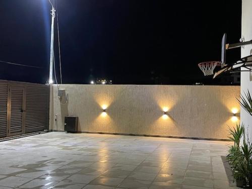a basketball hoop on a wall at night at Deadsea Elite First floor shared swimming pool in Sowayma