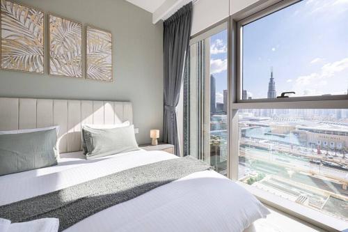 A bed or beds in a room at Downtown - Burj Khalifa Facing - 2 Bed Luxe Apartment