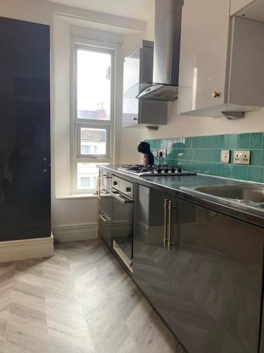 a kitchen with stainless steel appliances and a window at Central 2 bed flat. Free parking (Off-street) in Bristol