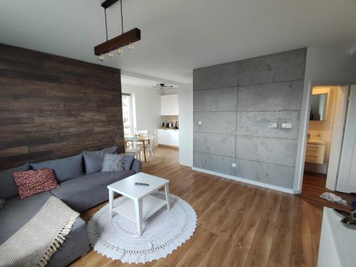 a living room with a couch and a table at Ustronny Zakątek in Ustroń