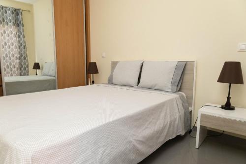 Кровать или кровати в номере Cidadela Apartment