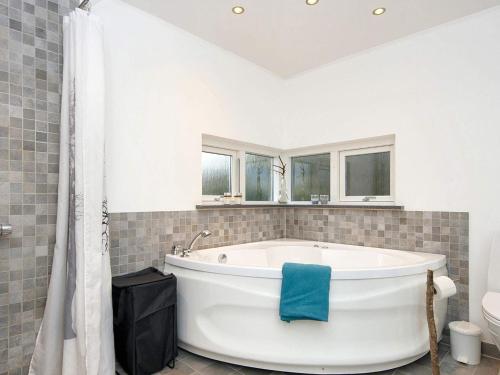 a white bath tub in a bathroom with windows at 6 person holiday home in Glesborg in Glesborg