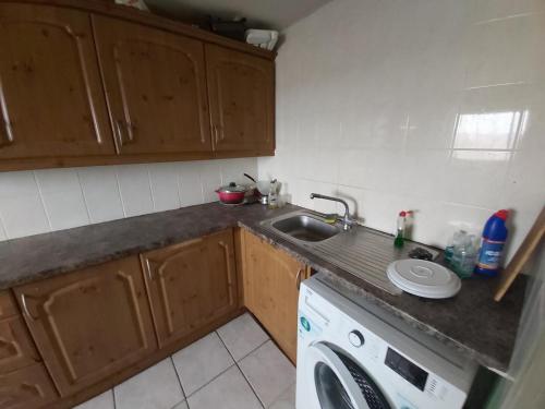 a kitchen with a sink and a washing machine at Essex Riverside in Grays Thurrock