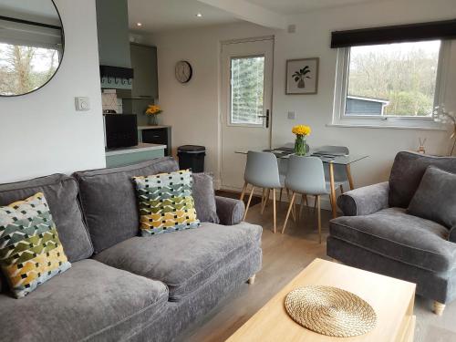 a living room with a couch and a table at Chalet 176 Glan Gwna Park Caernarfon in Caeathro