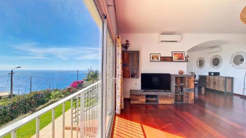 a balcony with a view of the ocean at Casa Eleanor by LovelyStay in Calheta