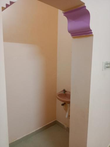 a bathroom with a toilet and a sink at SriArunachala Shiva home stay in Tiruvannāmalai