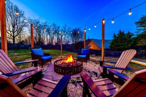 a fire pit in a yard with chairs and lights at King Beds, Views, EasyRoads, PoolTable, Spa, Theater, Outdoor fun in Sevierville