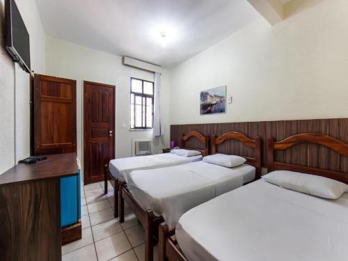 a group of four beds in a room at Hotel Netuno Beach in Fortaleza