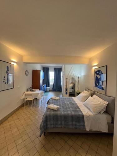 a bedroom with a large bed and a living room at Matteo's House Taormina in Taormina
