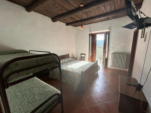 a bedroom with two bunk beds and a window at Agriturismo Macchiapiede in Sala Consilina