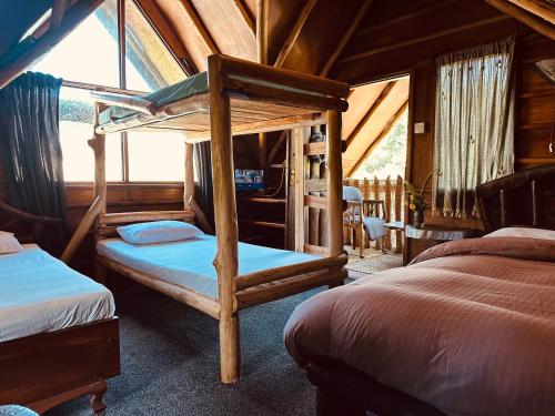 a bedroom with two bunk beds in a cabin at Villa 47 in Nuwara Eliya