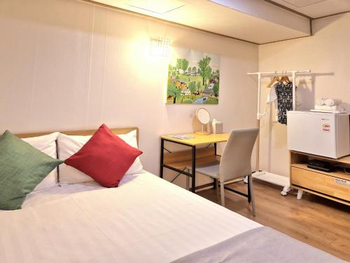 a bedroom with a bed and a desk and a table at K'STAY Sinchon in Seoul