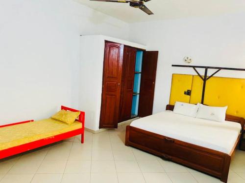 1 dormitorio con 2 camas y ventana en AULNES RESIDENCE HOTEL, en Cotonou