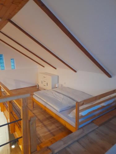 a bedroom with a bed in a attic at Kálvária Vendégház in Nagymaros