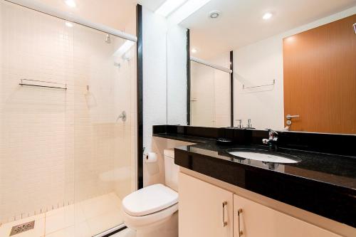 a bathroom with a toilet and a sink and a shower at BSB STAY Flats particulares - Athos SHN in Brasília
