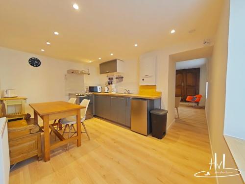 a kitchen with a table and a dining room at Maison Bedel, La Schlucht Gerardmer in Gérardmer