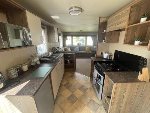a kitchen with a sink and a stove top oven at Breaks on the Lakes in Tattershall