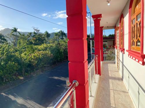 a red column on a building with a walkway at Hotel PedidoSia in Higuey