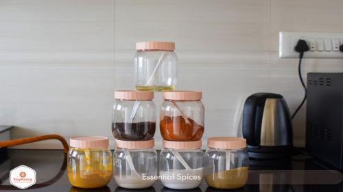 a group of glass jars sitting on top of a counter at StayMazing Manyata-1BHK Boutique AC Apartments in Bengaluru