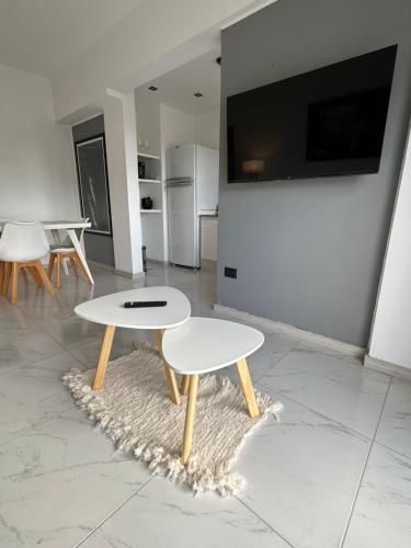a white table and stool in a room at Patagonia House - Mayo in Puerto Madryn