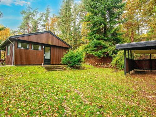 a small house in the middle of a yard at 4 person holiday home in Silkeborg in Silkeborg