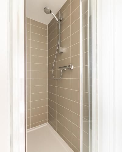 a shower with a shower head in a bathroom at Luxury Detached Home in Edinburgh