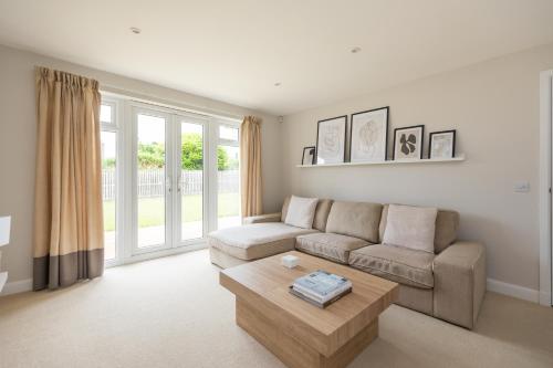 a living room with a couch and a coffee table at Luxury Detached Home in Edinburgh