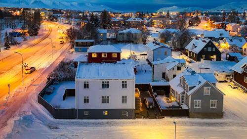 a city in the snow at night at G19 Boutique Apartments in Akureyri