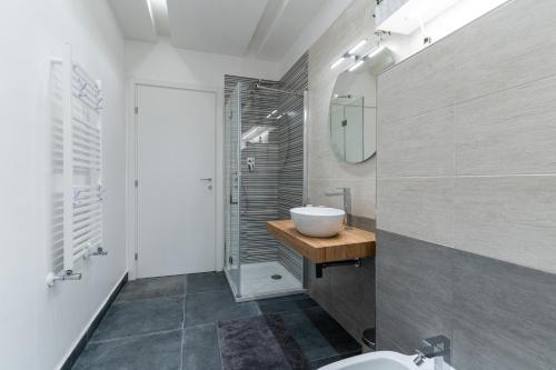 a bathroom with a sink and a toilet and a mirror at L'Onda Affittacamere in Civitavecchia