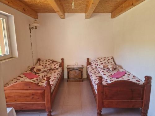 two twin beds in a room with at CAMPING ZELENI GAJ (GREEN FOREST) in Plužine