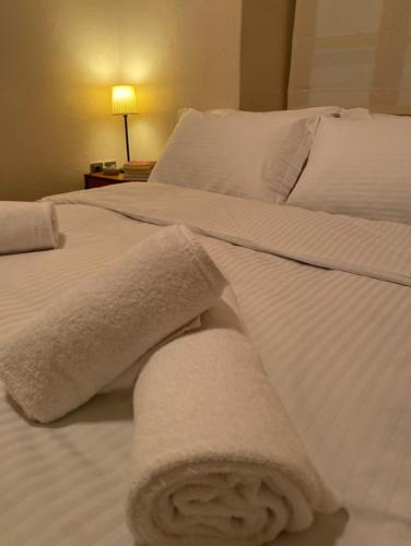 a white bed with towels on top of it at Arachova5634 in Arachova
