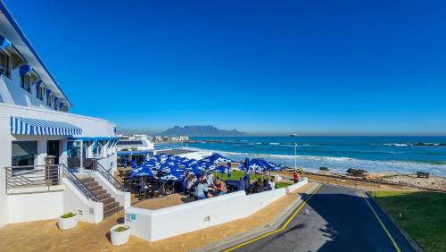 a view of the beach from the balcony of a building at The Blue Peter Hotel in Cape Town