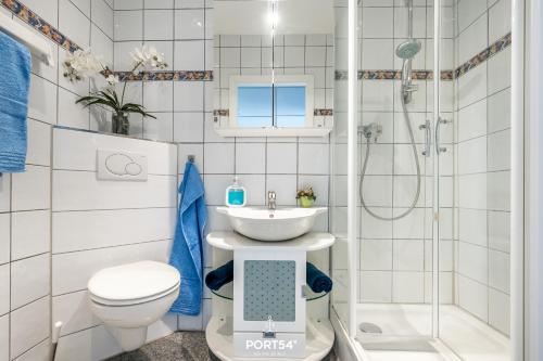 a bathroom with a sink and a toilet and a shower at Ferienwohnung Marina Apartment 9403 in Marina Wendtorf in Wendtorf