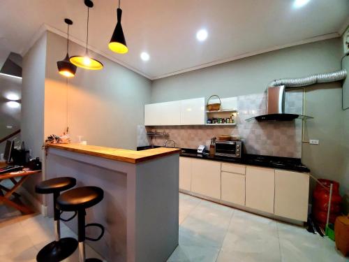 a kitchen with a counter and stools in it at Apartment in Vientiane