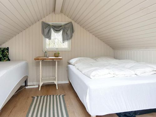 a bedroom with two beds and a window at Holiday home Sydals IV in Neder Lysabild